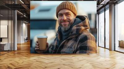 Male driver near a truck in a parking lot drinking coffee during a break after a long road Wall mural