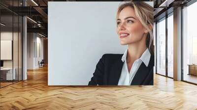 Portrait of smiling business woman boss in suit posing on grey studio background Wall mural