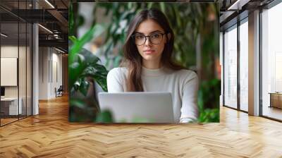 Professional businesswoman working on laptop in modern high-tech office Wall mural