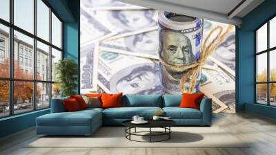 Roll of 100 dollar banknotes on dollars background Wall mural