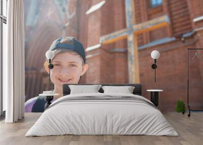 portrait of a 12 year old happy boy in front of a Catholic church	 Wall mural