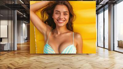 Smiling woman in a swimsuit with an inflatable beach mattress Wall mural