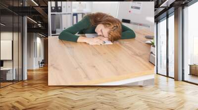 The girl was tired at work in the office, all day at the Desk Wall mural