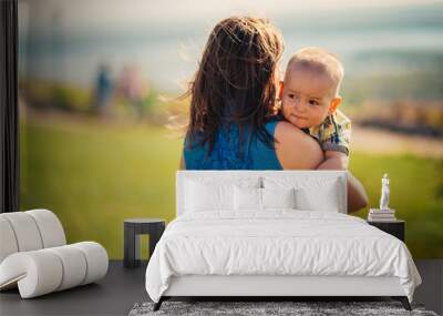 happy mother and toddler son on nature background Wall mural