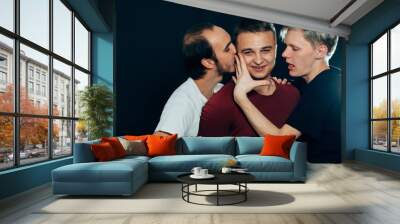 three guys are gay on dark background Wall mural