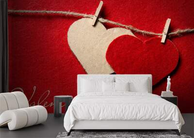 Valentine's day. Two hearts from felt and cardboard on rope with clothespin on red background with the gradient effect Wall mural