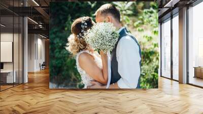 bride and groom together holding wedding bouquet Wall mural