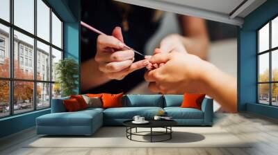 Woman in salon receiving manicure Wall mural