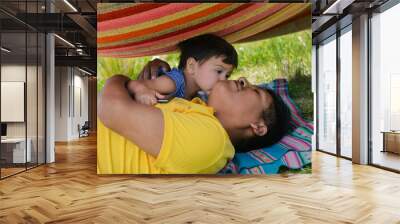 Tender portrait of indigenous South American man and his little son in the countryside. Wall mural