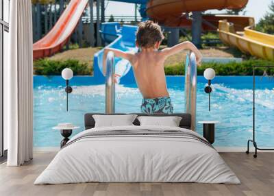 healthy small boy in shorts standing near summer blue swimming pool in water park Wall mural