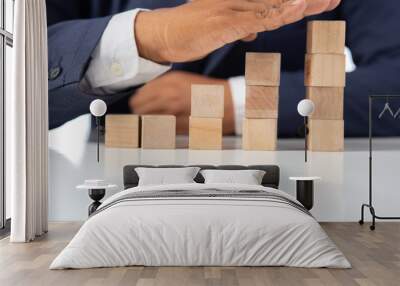 Businessman Wooden cubes on a desk in the office, Concept: Business to succeed that challenges teamwork, design development strategy investment, symbol Financial advisor shows  to asset growth Wall mural