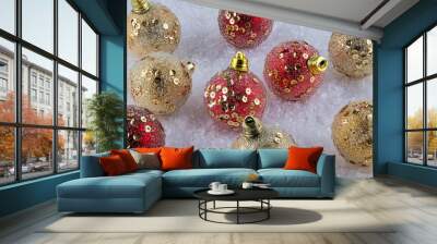 Red and Gold Christmas baubles on snow Wall mural