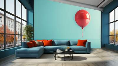 A red balloon floating against a light blue background, its reflective surface adding depth and interest to the simple composition. Wall mural