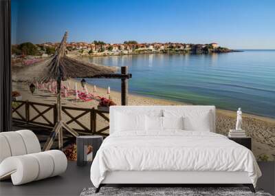 Seaside landscape - view of the cafe and the sandy beach with umbrellas and sun loungers in the town of Sozopol on the Black Sea coast in Bulgaria Wall mural