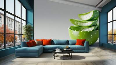 Aloe Vera Slices in a Decorative Bowl, vibrant green leaves stacked neatly, showcasing the succulent texture and soothing qualities of aloe, set against a subtle gray background. Wall mural