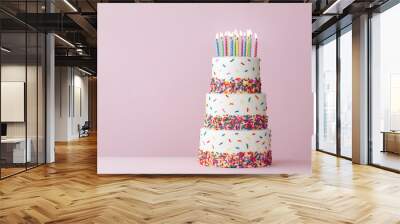 Tiered birthday cake with colorful sprinkles and birthday candles Wall mural