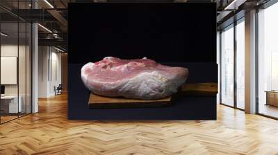 Pork meat on a black background. Raw pork leg. Fresh raw meat. Wall mural