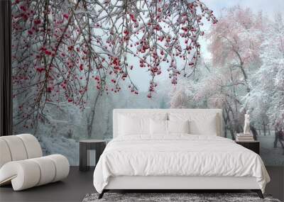 Winter city park at snowfall with red wild apple trees Wall mural