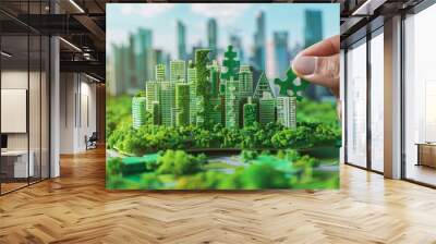 Hand carefully connects jigsaw puzzle pieces, featuring elements of a green cityscape, symbolizing the collaborative effort in building sustainable urban communities Wall mural