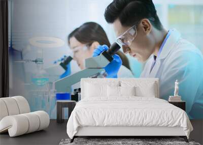 Asian scientist use microscope Wall mural