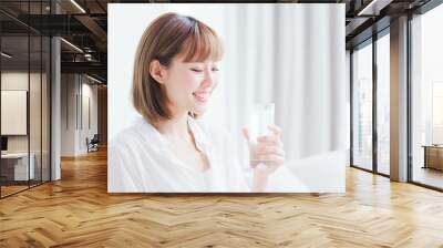 Beauty woman drink water happily Wall mural