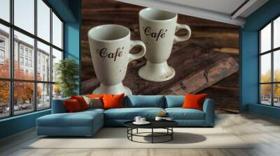 two cups on brown wooden plank on table Wall mural