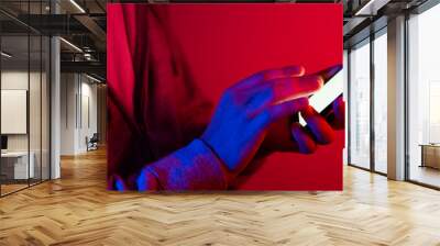 Male hands with smartphone. Empty white screen. Mock-up. Neon light Wall mural