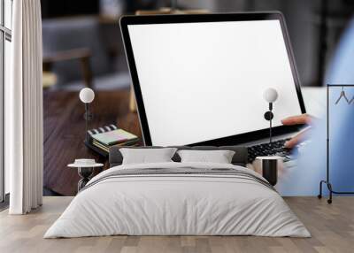 Mockup image of a woman using laptop with blank screen on wooden table Wall mural