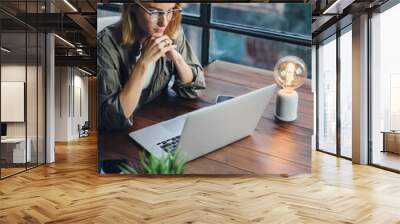 Woman working on laptop. Freelancer at remote work. Female student learning on-line via computer. Blogger or journalist writing new article. Wall mural