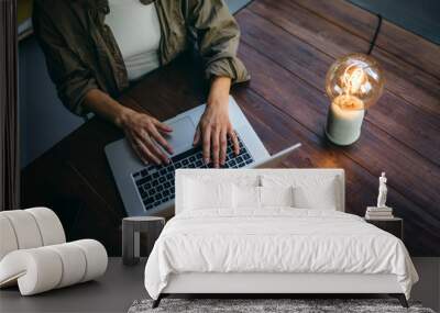 Young woman working with a laptop. Female freelancer connecting to internet via computer. Businesswoman at work Wall mural