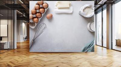 Ingredients for baking - Carton of eggs, flour, sugar and butter on concrete background. Recipe or cookbook concept. Copy space, top view Wall mural