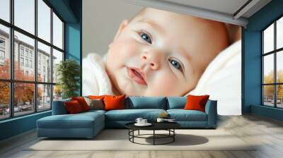 Close-up of a baby's face with blue eyes Wall mural