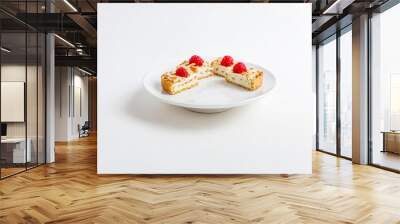 Closeup of two raspberry topped tarts on white plate Wall mural