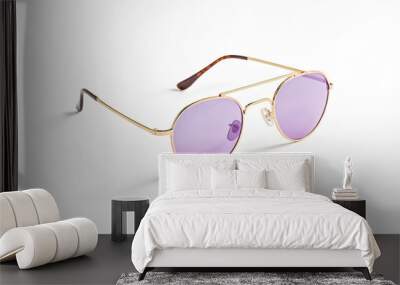 Gold Sunglasses with Purple Lenses on White Background Wall mural