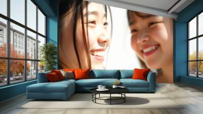 Two Young Women Smiling at Each Other Wall mural