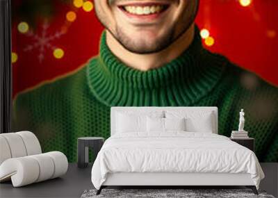 young man smiles joyfully while holding a christmas stocking filled with a present Wall mural