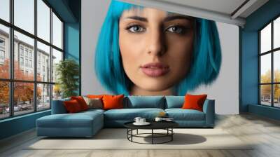 Beauty, fashion, makeup concept. Close-up studio portrait of beautiful and sexy woman in blue wig and yellow t-shirt looking to the camera. Wig with pixel stretch futuristic effect Wall mural