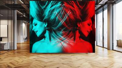 Fashion concept. Portrait of beautiful woman with flying hair in red and blue color split effect style. Futuristic looking style. Image contains motion blur. Model with happy facial expression Wall mural