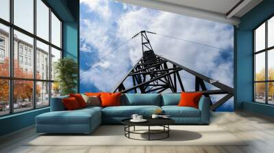 Metal electricity pole in blue sky with white clouds background Wall mural