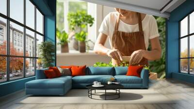 Asian Woman in Her 30s Tending to Microgreens in Sunlit Home Garden, Showcasing Simple Sustainable Home Agriculture Wall mural