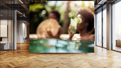 Relaxing Summer Day: Two Women Enjoying a Luxurious Spa Experience by the Pool with Palm Trees and Refreshing Drinks Wall mural