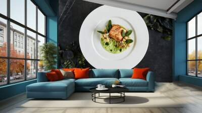 restaurant plate with fillet of salmon 48 degrees, green peas cream and burnt cauliflower top view Wall mural