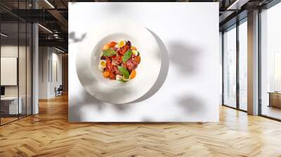 Salad with roast beef, vegetables and eggs on white table with harsh shadows. Steak salad in modern style with shadows of leaves. Flashy food. Meat salad with pastrami in summer menu. Wall mural