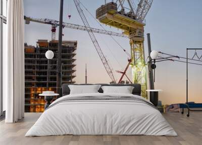 Toronto construction site with cranes and CN Tower at sunrise Wall mural