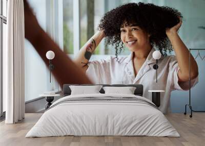 Beauty, hair and mirror with a black woman in the bathroom of her home for a morning haircare routine. Growth, wellness and keratin with an attractive young female styling her afro in the house Wall mural