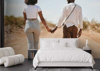 Black couple, love and holding hands back view in nature walking on vacation on desert, sand or dirt road. Romance, safari and man, woman and bonding, care or spending time together on outdoors date. Wall mural