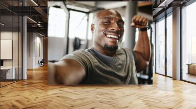 Black man, strong and fitness selfie, gym and exercise portrait, after workout and weight training, happy and flexing arm. Cardio, endurance and smile, sweat for sport and bicep photo, wellness. Wall mural