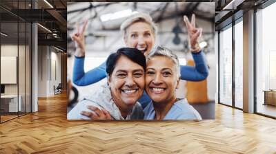 Business women, senior portrait and happiness of company friends in a warehouse with peace sign. Smile, teamwork hug and mature female group of happy entrepreneur staff ready for working together Wall mural