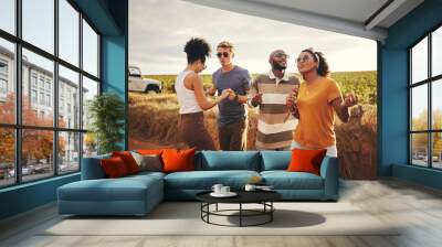 Diversity, friends and dance outdoor on holiday, vacation and relax together on dirt road trip in countryside. Group, students happy and travelling in summer for getaway or fun weekend away as couple Wall mural