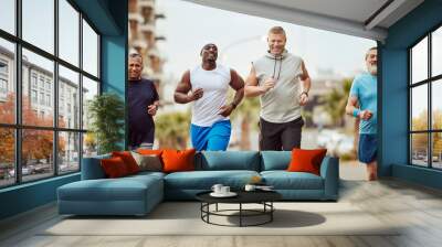 Fitness, running and teamwork with senior friends in city for stamina, cardio or endurance training. Sport, jogging and goal with group of men runner sprinting in town for workout, exercise or health Wall mural